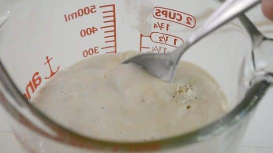 Foamy yeast bubbling in a measuring cup.