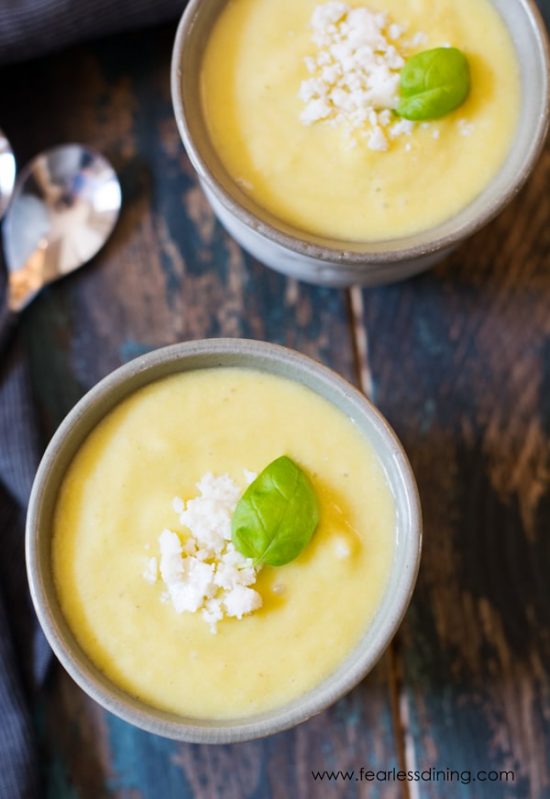 The top view of two small bowls of chilled pineapple soup.