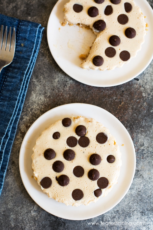 A top view of two mini peanut butter pies topped with chocolate chips.