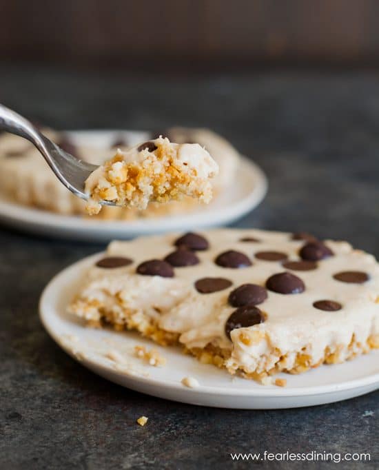 A fork taking a bite out of a gluten free peanut butter pie.