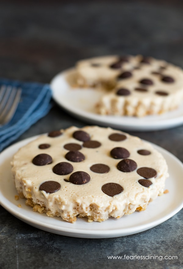 Gluten free peanut butter pies topped with chocolate chips. The pies are on white plates.
