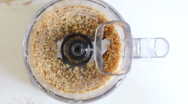 A food processor with graham cracker crumbs.