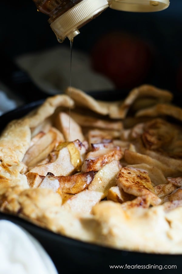 A baked gluten free apple galette in a cast iron skillet.