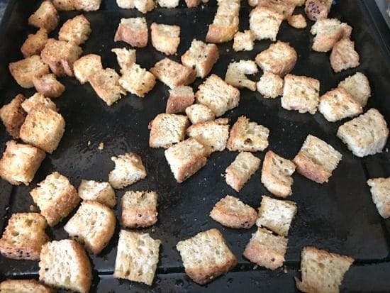 Baked gluten free croutons on a baking sheet.