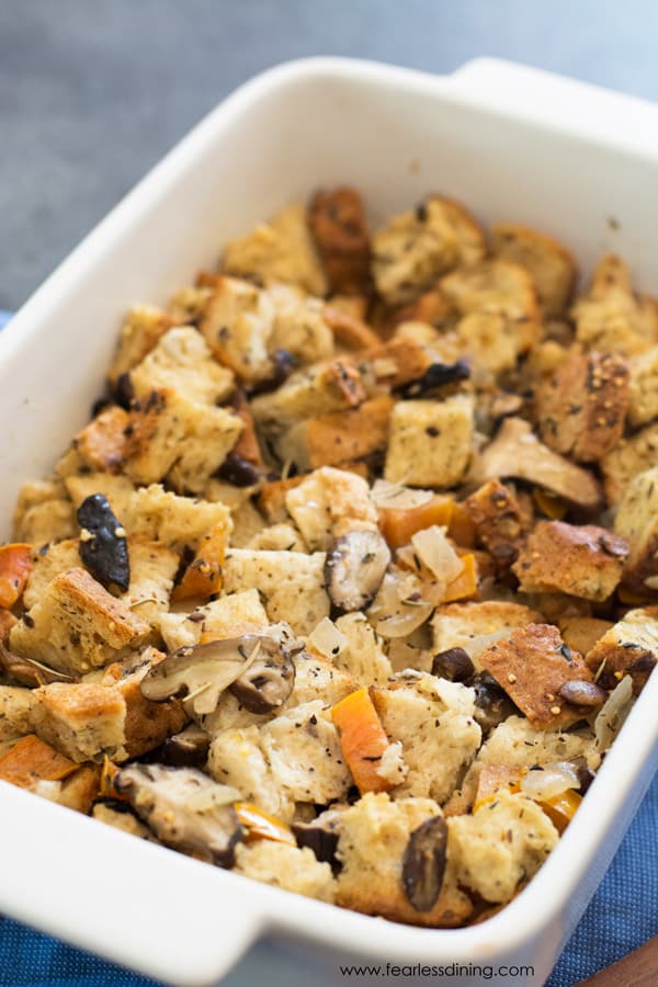 A white baking dish filled with gluten free mushroom stuffing