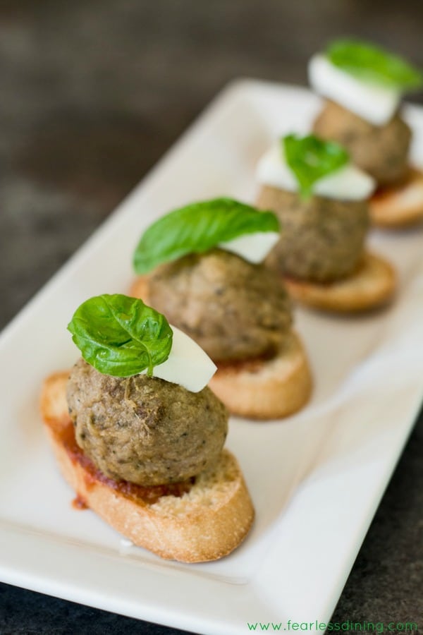 Meatball crostini on a serving tray.