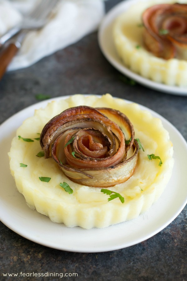 Mashed Potato bacon rose tarts on small white plates.