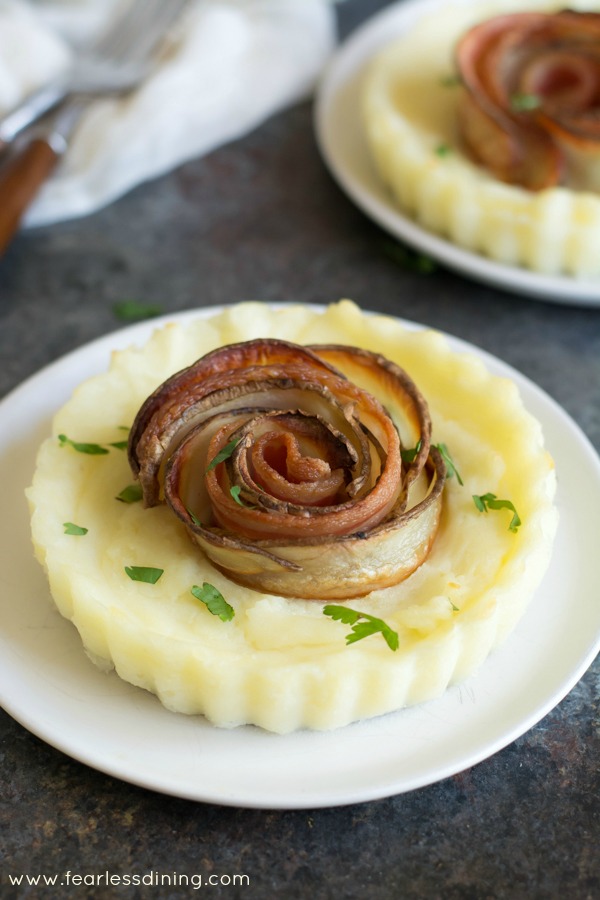 Mashed potato pies with crispy bacon potato roses on top.