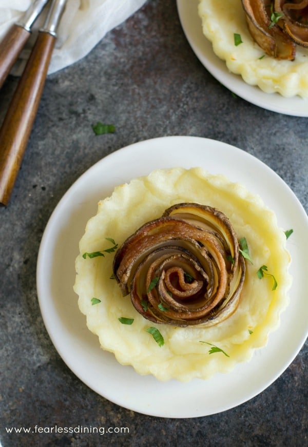 Top view of a mashed potato pie with a crispy potato bacon rose in the midle.