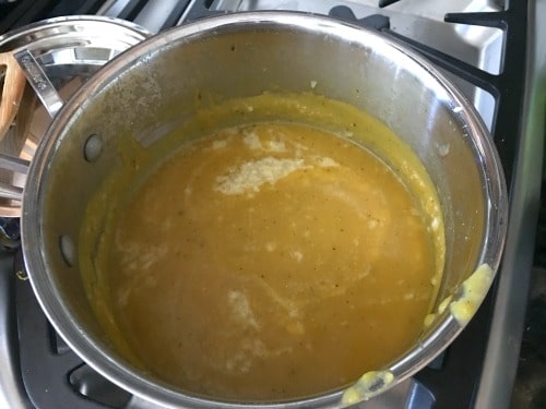 Acorn squash soup cooking in a soup pot.