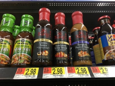 Bottles of Tsang's gluten free Asian sauces on a shelf.