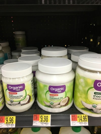 Jars of organic coconut oil on a shelf.