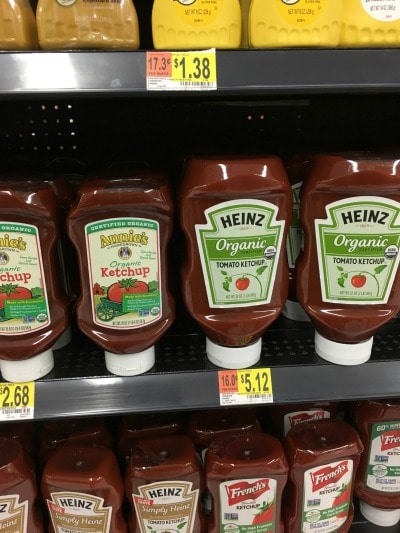 Organic ketchup bottles on a shelf.