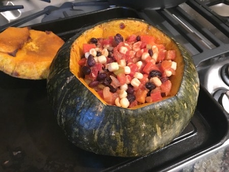 A kabocha squash stuffed with a Mexican flavored corn and tomato dish.