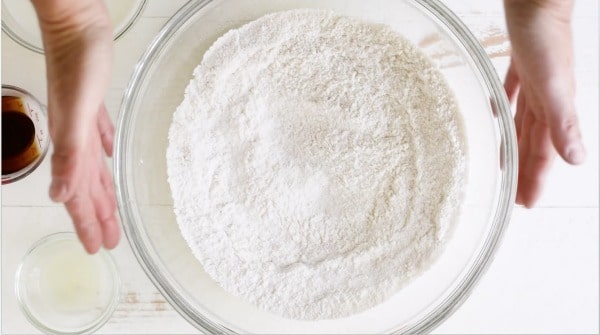 Whisked dry ingredients in a glass mixing bowl.