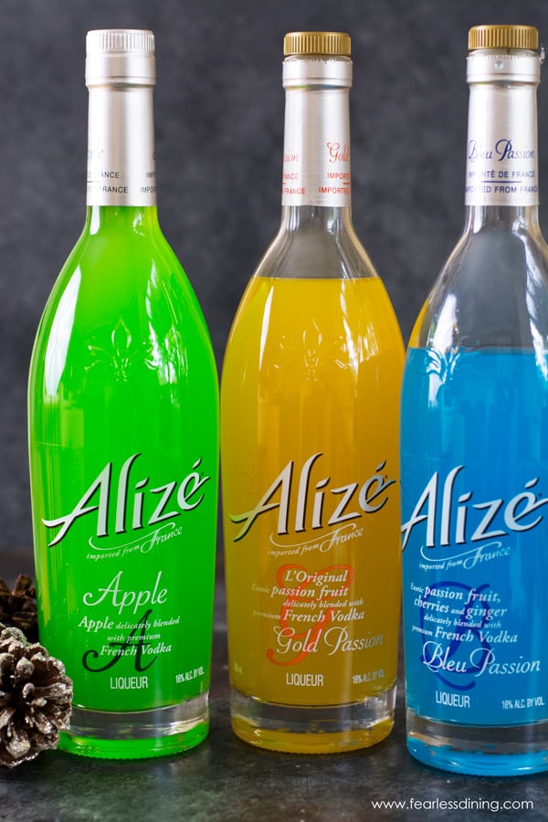 Three bottles of Alize Vodka.