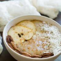 A bowl of pear smoothie on a table.