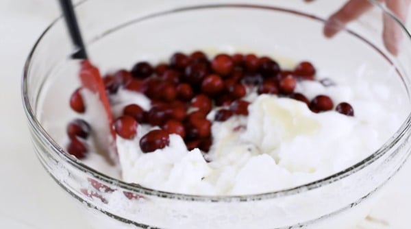 Gently folding in the cranberries into the egg white mixture.