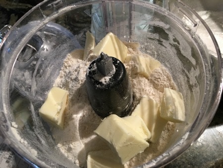 Butter, almond flour, and gluten free flour in a food processor.