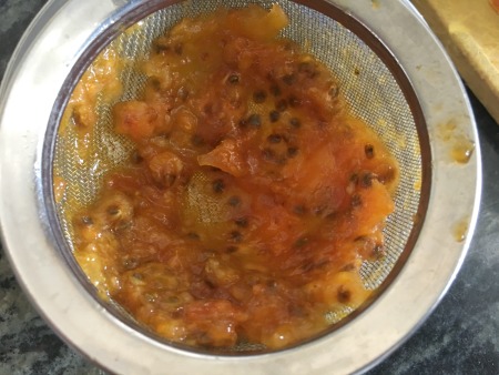 Prickly pear pulp and seeds in a strainer.