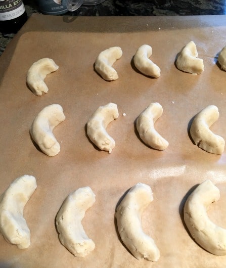 Vanillekipferl on a baking tray ready to bake.