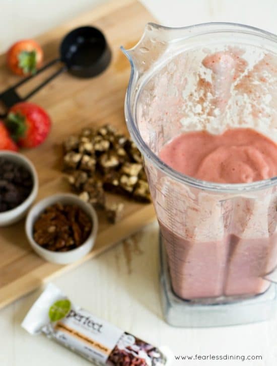 a vitamix filled with strawberry smoothie
