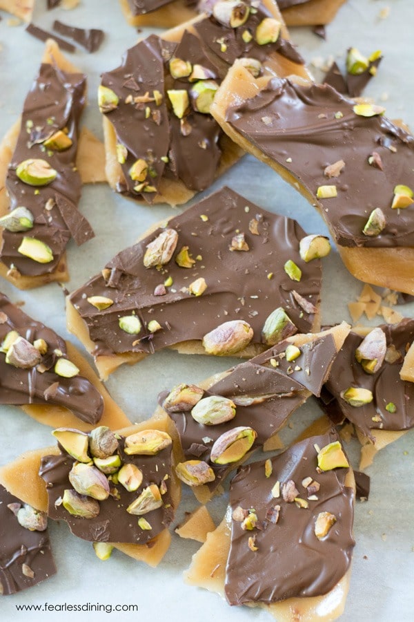 Homemade toffee candy with chocolate and pistachios on top.