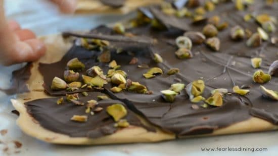 Breaking homemade toffee into pieces.