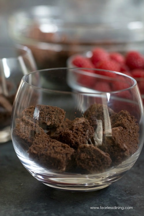 Adding cake squares to a glass.