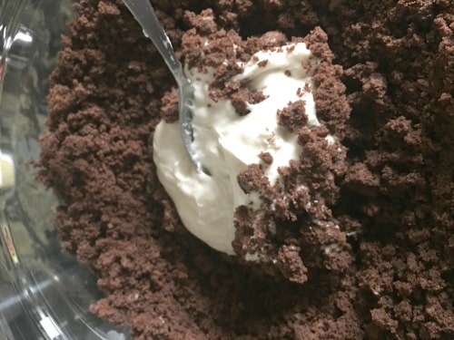 Vanilla frosting in the chocolate cake bowl.