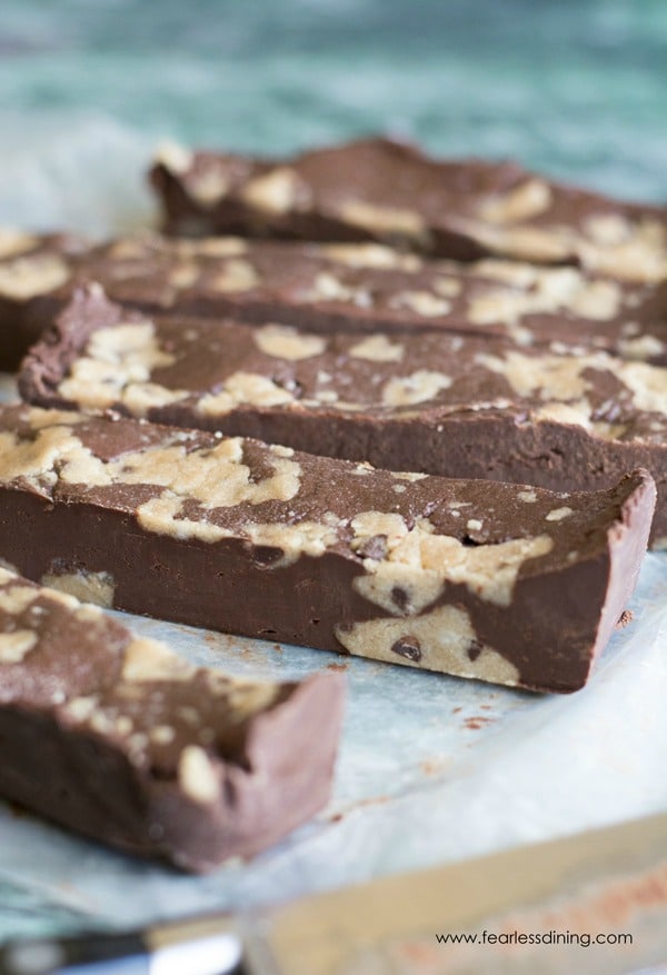 Strips of gluten free cookie dough fudge on a piece of wax paper.