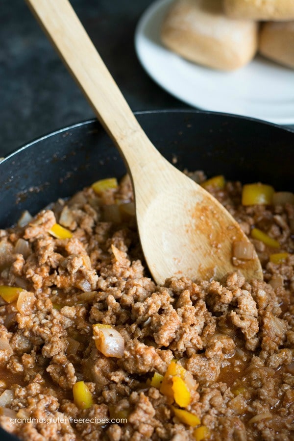 A pot filled with cooked sloppy Joe meat mixture.