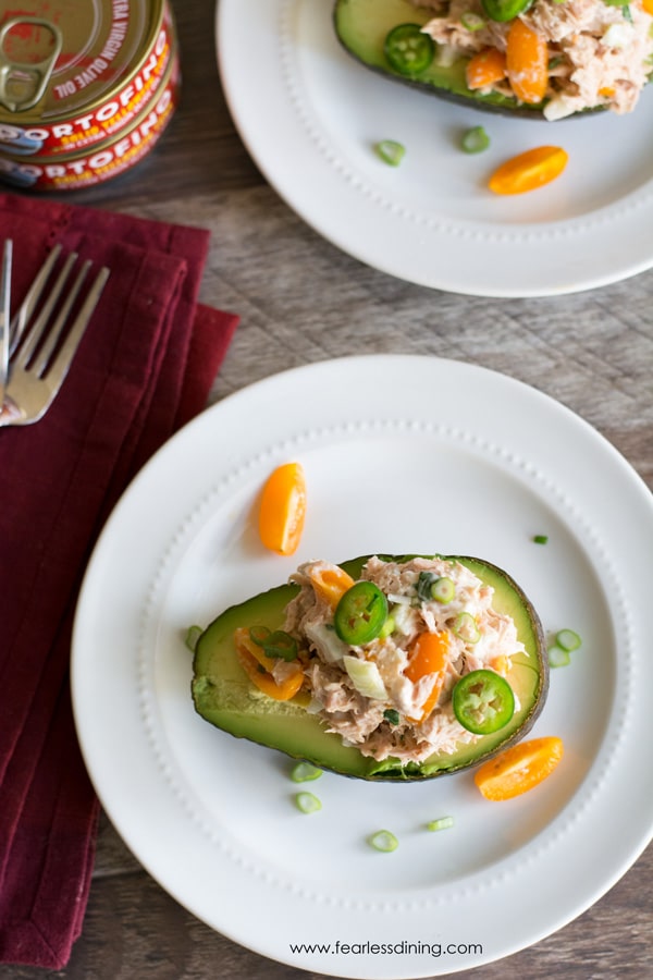 The top view of a tuna salad stuffed avocado on a plate.