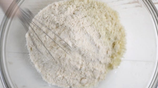 Whisking the dry ingredients in a mixing bowl.