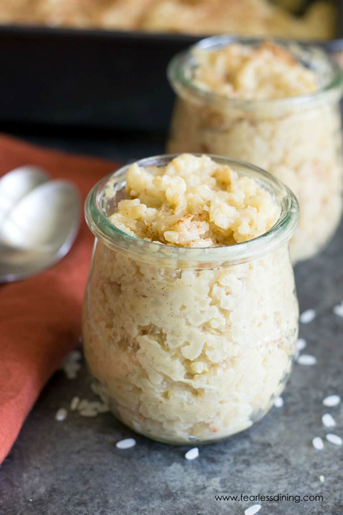Two glass bowls filled with rice pudding.