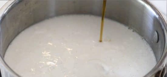 pouring vanilla into the milk