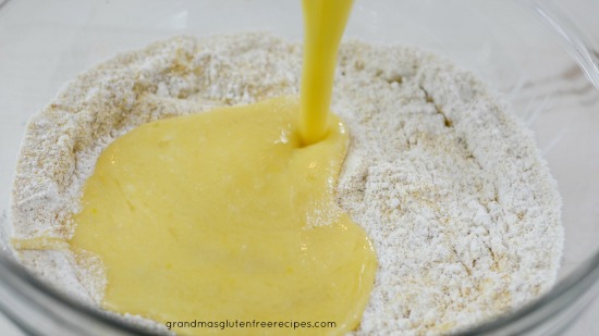 Pouring wet ingredients into the dry ingredients for this German apple cake recipe.