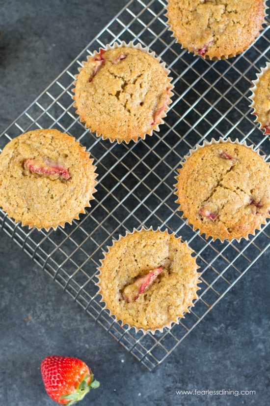 The top view of strawberry muffins on a cooling rack.