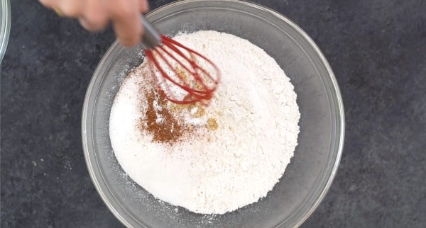 Whisking dry ingredients in a bowl.