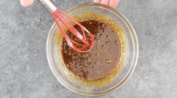 The wet ingredients with molasses mixed in a bowl.
