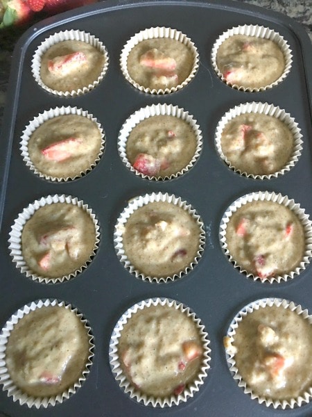 A photo of the muffin batter in a muffin tin.
