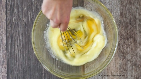 Whisking the wet ingredients in a glass bowl.