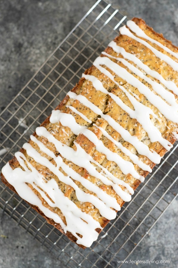 The top view of a whole gluten free lemon poppy seed loaf with lemonade icing.