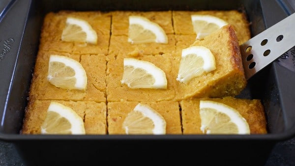 cutting out a lemon square from the pan