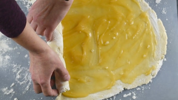 rolling the lemon curd and dough into a roll