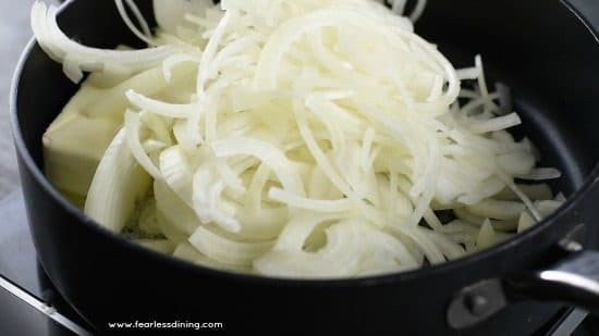 Adding sliced onions to the pan.