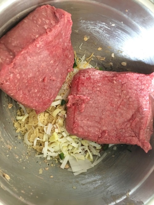 Ground beef added to meatloaf ingredients.