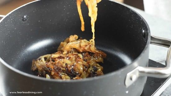 Holding up the caramelized onions.