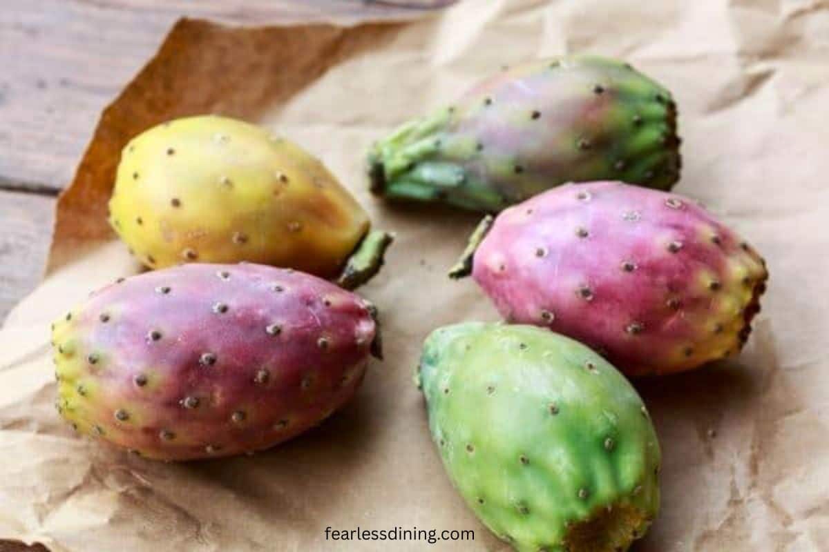 Several colors of prickly pears on a paper bag.