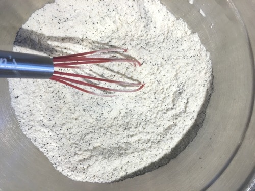 The muffin dry ingredients in a bowl with a whisk.
